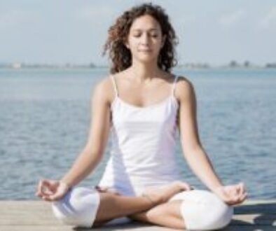 A lady practicing Pranayama in Padmasana, the cross-legged lotus pose.
